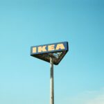 a ikea sign on a pole against a blue sky
