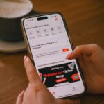 A person uses a phone with the tiktok shop app.