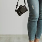 a person holding a camera in their right hand