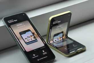 Two cell phones sitting next to each other on a window sill