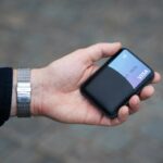 a person holding a cell phone in their hand