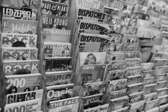 Magazines and newspapers displayed on a rack