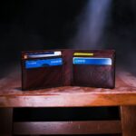 brown leather bifold wallet on table