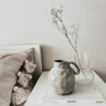 white ceramic vase on white book