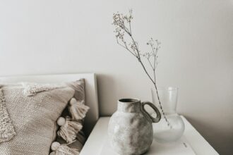 white ceramic vase on white book