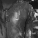 grayscale photo of man in henley shirt
