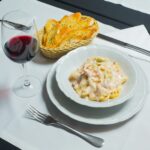 white ceramic plate with stainless steel fork and bread knife