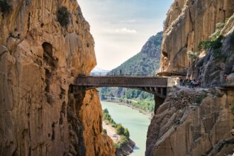 A bridge over a river between two mountains