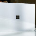 A white laptop sitting on top of a table