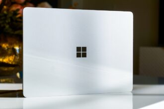 A white laptop sitting on top of a table