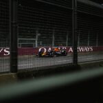 A race car is driving on the track.