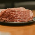 A piece of meat on a plate on a table