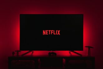a television with the netflix logo lit up in the dark