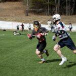 lacrosse players on sports field