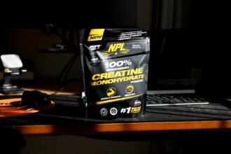 A bag of creatinne on a desk next to a keyboard