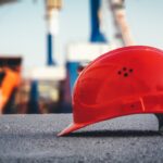 red hard hat on pavement