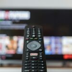 black remote control on brown wooden table