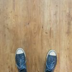 person wearing blue-and-white low-top sneakers