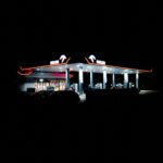 a gas station lit up at night in the dark