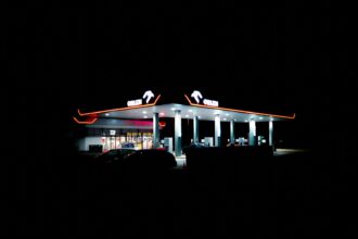 a gas station lit up at night in the dark