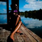 woman sitting near body of water