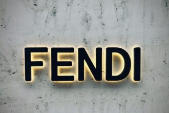 the word fendi spelled with neon lights on a wall