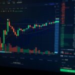 A digital candlestick chart showing cryptocurrency market trends on a dark computer screen